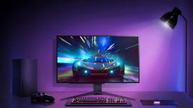 LG 27GR95QE oled monitor shown on a desk with a keyboard, mouse, controller, xbox series x and other gaming gear