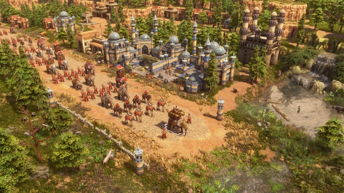 Camels and elephants parade through a town in Age Of Empires 3: Definitive Edition