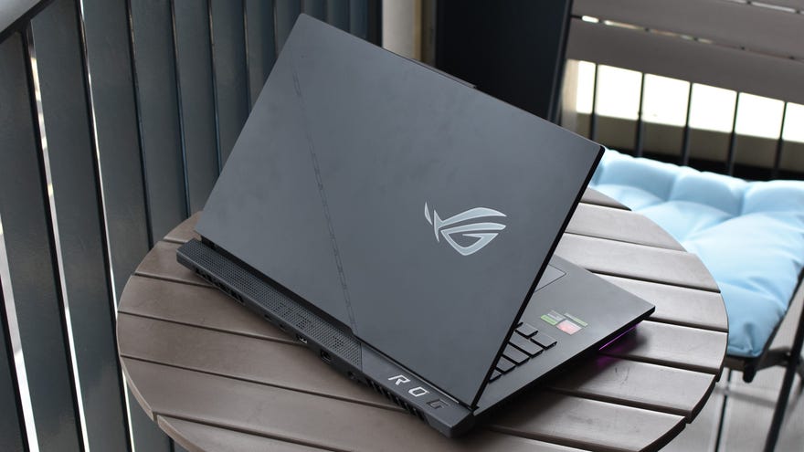 The lid of the Asus ROG Strix Scar 17 gaming laptop, which is sat on a small table.