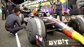 A man crouches to talk to a driver in an F1 car in F1 Manager 2023